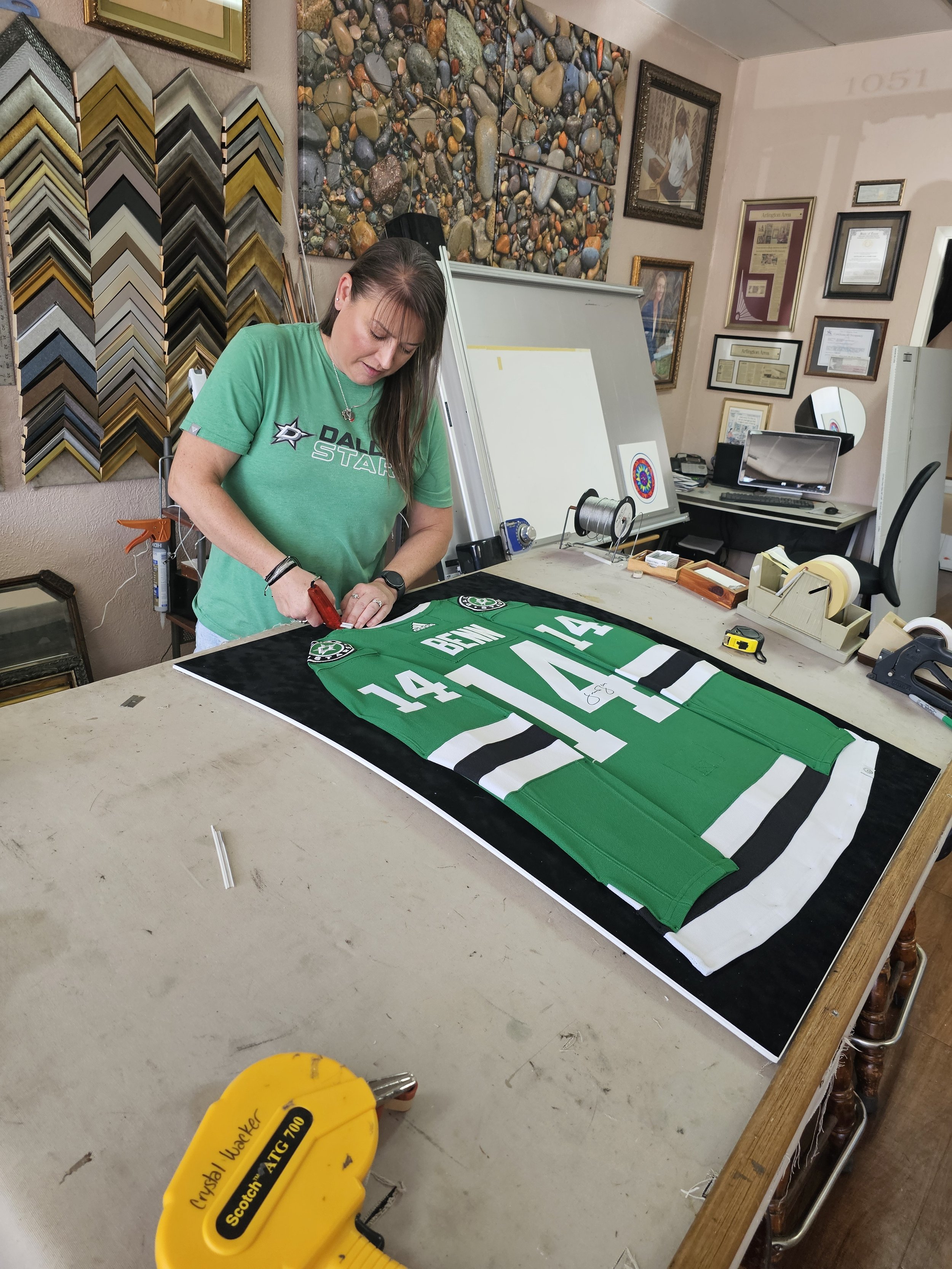 Crystal Lynn custom framing a sports jersey at Kar Lynn Arts